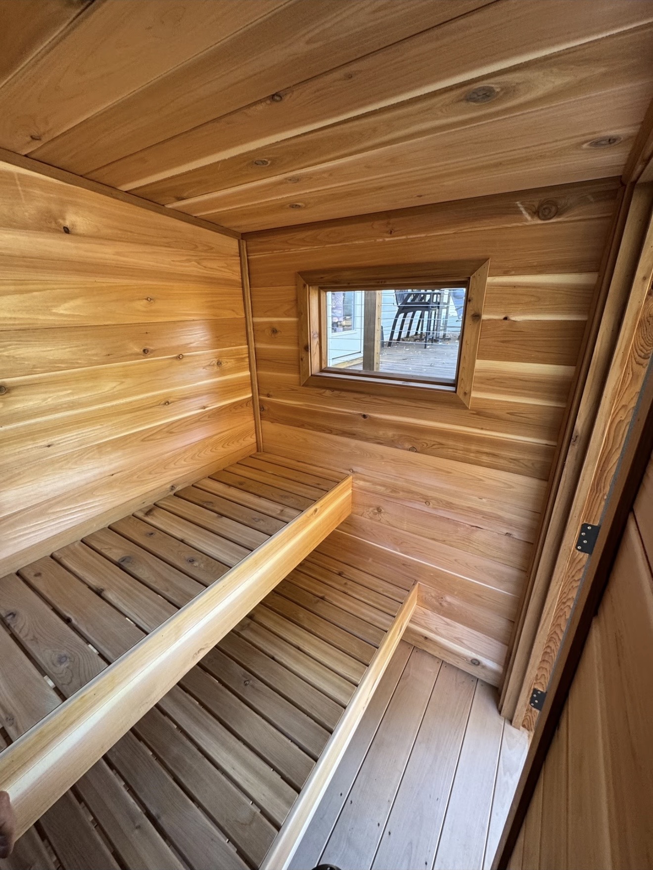 Two levels of cedar benches with a framed side window